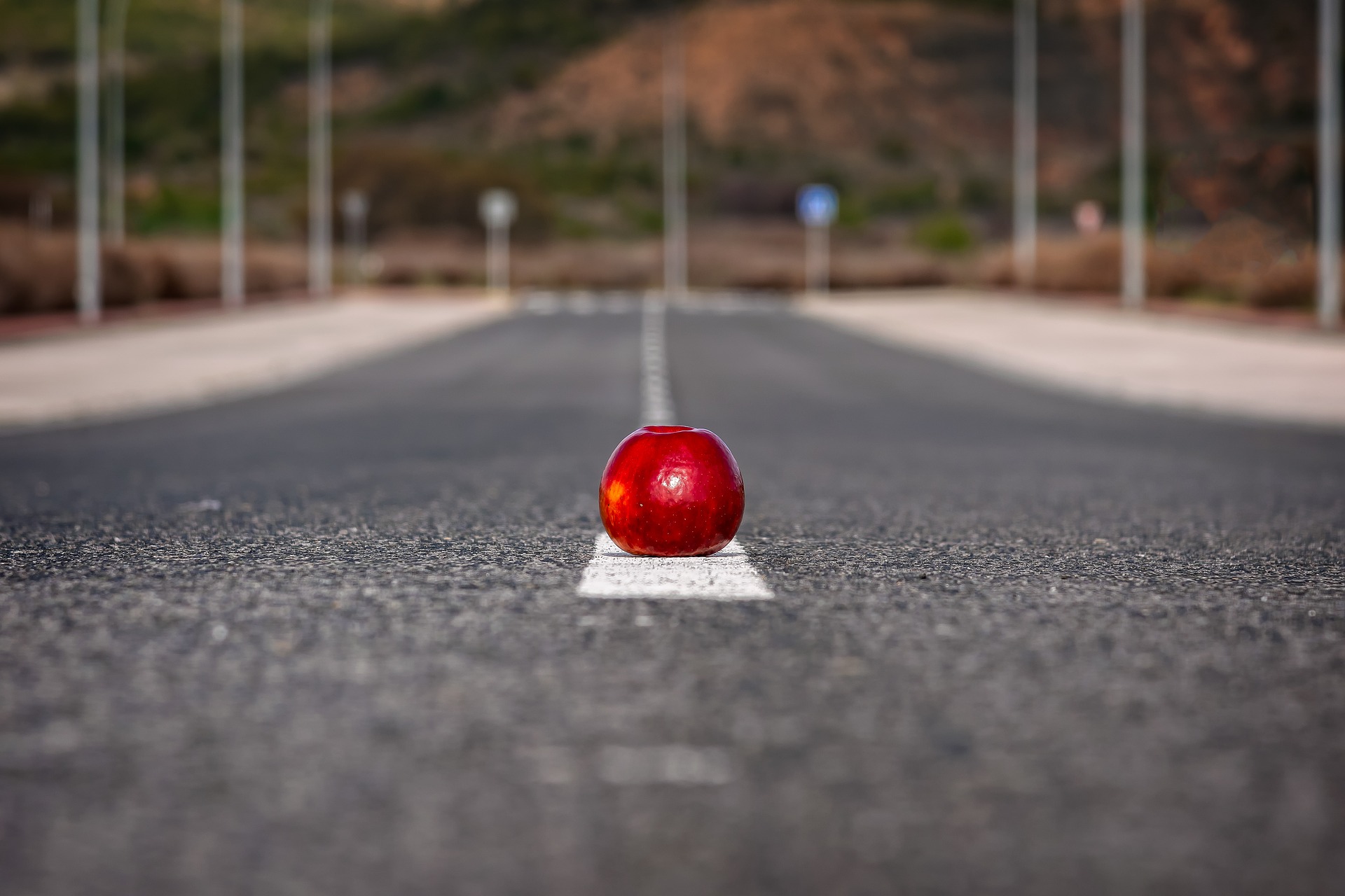 rdeče jabolko na sredini ceste