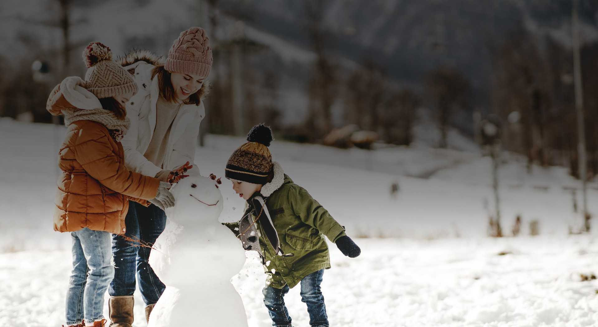 snežak, družina na snegu, otroci, WIZ blog Prihranek na počitnicah, tudi v Tujini